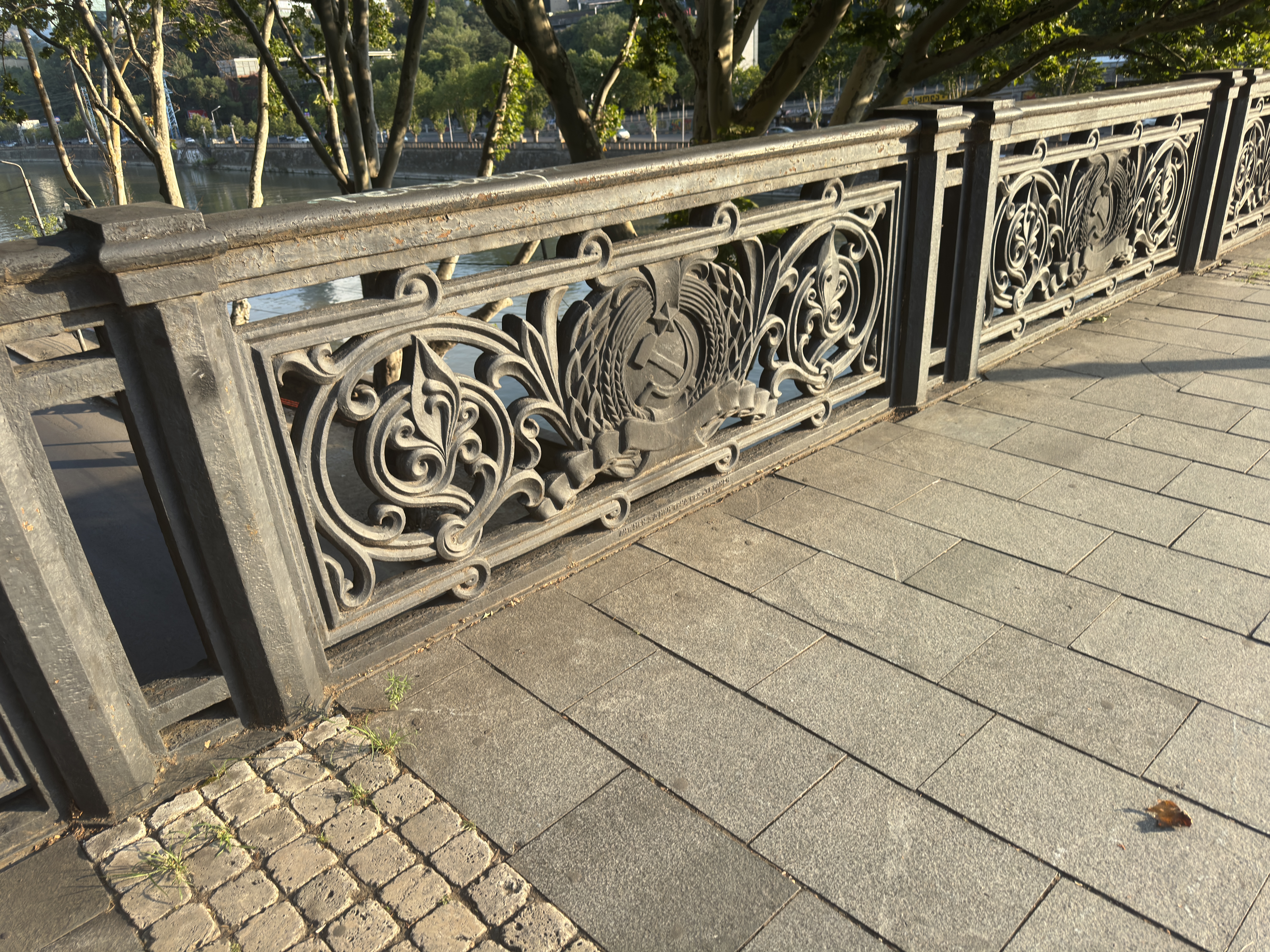 Close-up of the Cyrillic marking on the Soviet iron railing in Tbilisi.